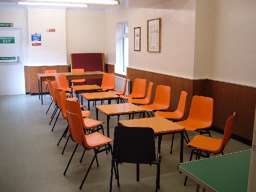 The Committee Room, tables and orange chairs in meeting room