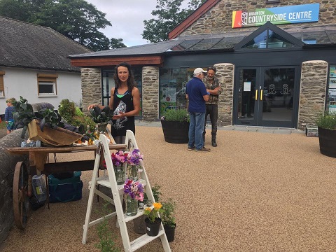 Community Shared Space, Outside area of Braunton Countryside Centre with lady selling vegetable from a cart