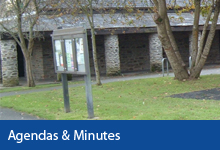Agendas & Minutes button, Braunton Countryside Centre building and Parish noticeboard on grassed area