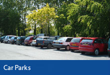 Car Parks button, cars parked in Caen Street Car Park Braunton with trees in the background