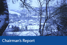 Chairman's Report button, view of snow scene of Braunton through trees