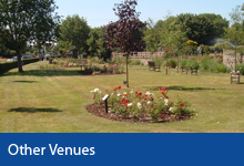 Other Venues button, Rose bed, grass and trees in Memorial Gardens in Braunton